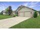 Charming home featuring a two-car garage, front lawn, and ample driveway space at 3287 Buckmoor Pkwy, Greenwood, IN 46143
