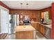 This kitchen features stainless steel appliances, wooden cabinets, and a center island at 3287 Buckmoor Pkwy, Greenwood, IN 46143