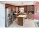 This kitchen features stainless steel appliances, light countertops, wooden cabinets, and a center island at 3287 Buckmoor Pkwy, Greenwood, IN 46143