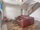 Cozy living room with hardwood floors, modern furniture, and a staircase, creating a welcoming atmosphere at 3287 Buckmoor Pkwy, Greenwood, IN 46143