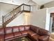 This living room features a beautiful stairway and large sectional couch at 3287 Buckmoor Pkwy, Greenwood, IN 46143