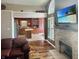 Open-concept living area with hardwood floors, a fireplace, and a view into the kitchen at 3287 Buckmoor Pkwy, Greenwood, IN 46143