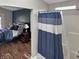 The main bedroom features wood floors, an ensuite bathroom, and a large bed with blue bedding at 3287 Buckmoor Pkwy, Greenwood, IN 46143