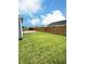 Spacious backyard with a wooden fence and a deck perfect for outdoor entertaining at 3341 Orchard Valley Dr, Columbus, IN 47203