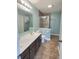 Well-lit bathroom features double sink vanity and glass-enclosed shower at 3341 Orchard Valley Dr, Columbus, IN 47203