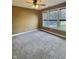 Bright, carpeted bedroom with a ceiling fan and natural light from a large window at 3341 Orchard Valley Dr, Columbus, IN 47203
