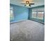 Spacious bedroom with neutral carpet, ceiling fan, and ample natural light from two windows at 3341 Orchard Valley Dr, Columbus, IN 47203