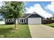 Charming blue home with a two-car garage and a well-manicured lawn at 3341 Orchard Valley Dr, Columbus, IN 47203