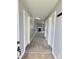 Inviting hallway with neutral paint, multiple doors, and a view of the fireplace at 3341 Orchard Valley Dr, Columbus, IN 47203