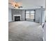 Spacious living room with neutral carpet, fireplace, ceiling fan and bright window at 3341 Orchard Valley Dr, Columbus, IN 47203