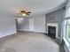 Bright living room featuring a fireplace, neutral carpet, and a ceiling fan at 3341 Orchard Valley Dr, Columbus, IN 47203
