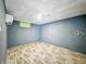 An unfinished basement bedroom showcasing blue accent walls and laminated floor at 3422 Hillside Ave, Indianapolis, IN 46218