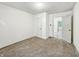 A bright bedroom featuring neutral walls, brown carpeting, and a doorway leading to another room at 3422 Hillside Ave, Indianapolis, IN 46218