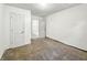 A bright bedroom featuring neutral walls, brown carpeting, and a doorway leading to another room at 3422 Hillside Ave, Indianapolis, IN 46218