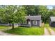 Charming single-story home featuring a covered front porch and mature landscaping at 3422 Hillside Ave, Indianapolis, IN 46218