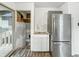 Kitchen space showing stainless steel refrigerator and access to the outdoor deck at 3422 Hillside Ave, Indianapolis, IN 46218
