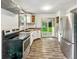 Kitchen featuring stainless steel appliances, white cabinets, and access to deck at 3422 Hillside Ave, Indianapolis, IN 46218