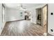 Bright, open-concept living space with wood-look floors, fan, and view to the kitchen at 3422 Hillside Ave, Indianapolis, IN 46218