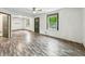 Spacious living room with hardwood floors and large windows that provide natural light at 3422 Hillside Ave, Indianapolis, IN 46218
