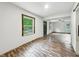 Spacious living room features wood-look floors and natural light through the windows at 3422 Hillside Ave, Indianapolis, IN 46218