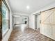 Open-concept living room with wood-look floors, and sliding barn door accent at 3422 Hillside Ave, Indianapolis, IN 46218