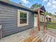 Low angle from the side of the house captures the wooden deck, exterior paint, and roof at 3422 Hillside Ave, Indianapolis, IN 46218