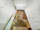 View down unfinished stairs to basement with brick chimney at 3422 Hillside Ave, Indianapolis, IN 46218