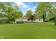 Spacious backyard with lush lawn and mature trees offering a serene outdoor living space at 3841 Meridee Dr, Indianapolis, IN 46237