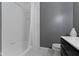 Clean bathroom featuring a shower with white tiles and a vanity, designed for a fresh and modern feel at 3841 Meridee Dr, Indianapolis, IN 46237