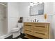 Stylish bathroom features a wooden vanity, black hardware, and a glass-enclosed shower for a modern feel at 3841 Meridee Dr, Indianapolis, IN 46237