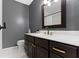 Elegant bathroom with a dark vanity, gold fixtures, and a large mirror, offering a luxurious and modern feel at 3841 Meridee Dr, Indianapolis, IN 46237