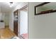 Foyer with an open front door, hardwood floors, coat rack, and mirror at 3841 Meridee Dr, Indianapolis, IN 46237