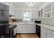 Well-lit kitchen with white cabinets, modern appliances, and stylish backsplash at 3841 Meridee Dr, Indianapolis, IN 46237