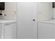 Laundry area with white washer and dryer, storage cabinets, and black hardware at 3841 Meridee Dr, Indianapolis, IN 46237