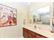 Bright bathroom with a marble countertop, large mirror and decorative artwork at 392 Sandbrook Dr, Noblesville, IN 46062