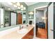 Bright bathroom features a large mirror, modern fixtures, and seamless transition into a cozy living space at 392 Sandbrook Dr, Noblesville, IN 46062