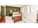 Charming bedroom with a vintage wooden dresser, plantation shutters, and carpeted floors at 392 Sandbrook Dr, Noblesville, IN 46062