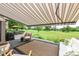 Inviting covered deck with awning offers stunning views of the lush green lawn and mature trees beyond at 392 Sandbrook Dr, Noblesville, IN 46062