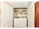 Cozy laundry closet with open shelving and a new washer and dryer at 392 Sandbrook Dr, Noblesville, IN 46062