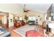 Open-concept living room with hardwood floors, large windows, a ceiling fan, and neutral paint at 392 Sandbrook Dr, Noblesville, IN 46062