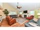 Bright living room features a fireplace, ceiling fan, hardwood floors, and abundant natural light at 392 Sandbrook Dr, Noblesville, IN 46062
