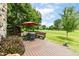 Expansive deck with outdoor dining set provides a perfect spot for relaxation and enjoying the serene landscape at 392 Sandbrook Dr, Noblesville, IN 46062