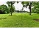 Expansive backyard view featuring lush greenery, mature trees, and the rear facade of the home at 4115 Tansel Rd, Indianapolis, IN 46234