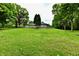 Large, well-maintained lawn and mature trees in the backyard, offering privacy at 4115 Tansel Rd, Indianapolis, IN 46234