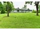 Expansive backyard featuring well-maintained lawn and the home's exterior with a deck at 4115 Tansel Rd, Indianapolis, IN 46234