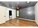 Open bedroom with modern ceiling fan, wood floors, and an en suite bathroom at 4115 Tansel Rd, Indianapolis, IN 46234