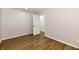 This bedroom features wood-look floors and neutral walls, with a door leading to the rest of the house at 4115 Tansel Rd, Indianapolis, IN 46234