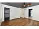 Open bedroom with wood floors, closet and bathroom access, and a ceiling fan at 4115 Tansel Rd, Indianapolis, IN 46234