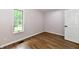 This bedroom features wood-look floors, neutral walls and a window to provide lots of natural light at 4115 Tansel Rd, Indianapolis, IN 46234