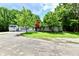 Charming single-story home featuring lush greenery, an attached garage, and a private driveway at 4115 Tansel Rd, Indianapolis, IN 46234